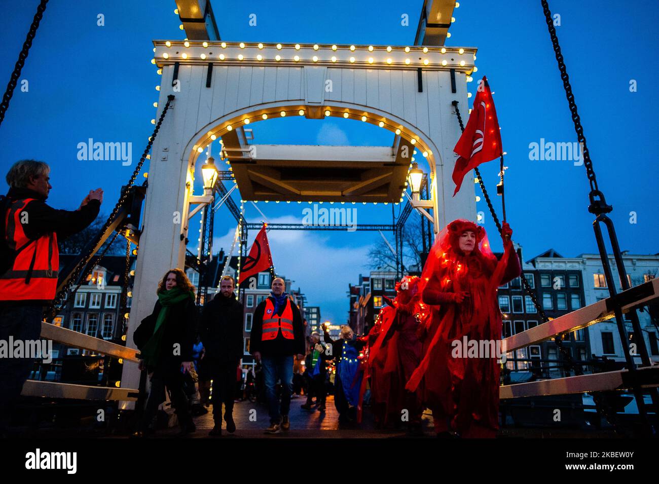 The Red Rebel Brigade is crossing one of the famous bridges in Amsterdam, during the Extinction Rebellion artistic march, on January 18th, 2020 (Photo by Romy Arroyo Fernandez/NurPhoto) Stock Photo