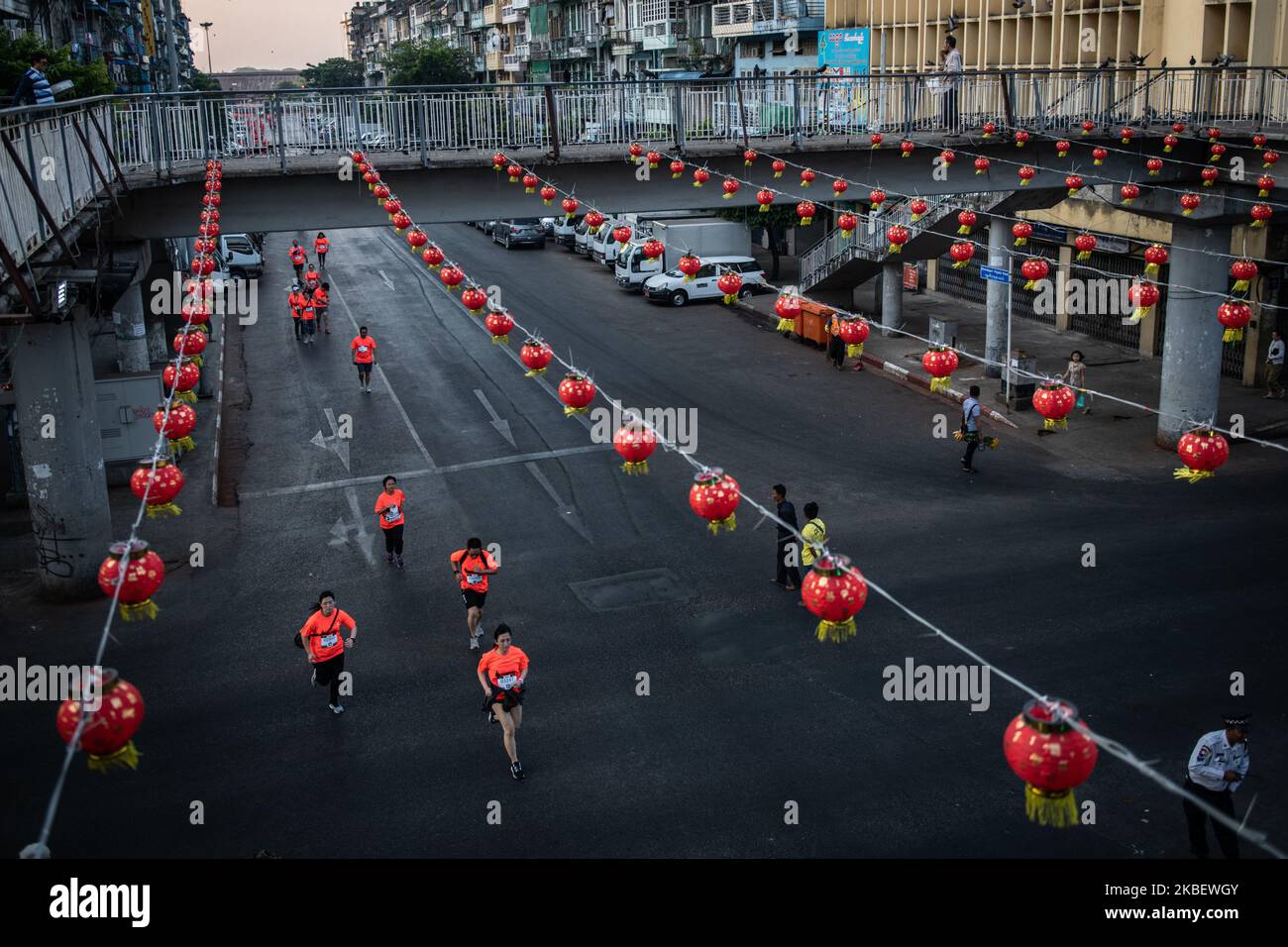 Runners run under Lunar New Year decorations paper lantern at Chinatown district in Yangon, Myanmar on 19 January, 2020. Chinese Lunar New Year also known as the Spring Festival, falls on January 25 this year and marks the start of the Year of Rat. (Photo by Shwe Paw Mya Tin/NurPhoto) Stock Photo