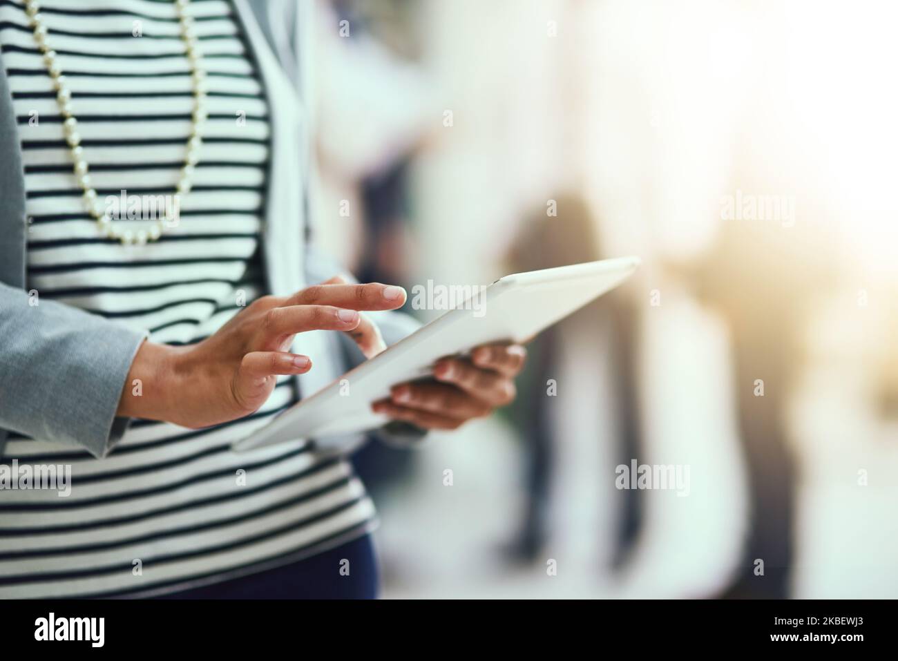 Productivity in her hands. an unrecognisable businesswoman using a digital tablet in an office. Stock Photo