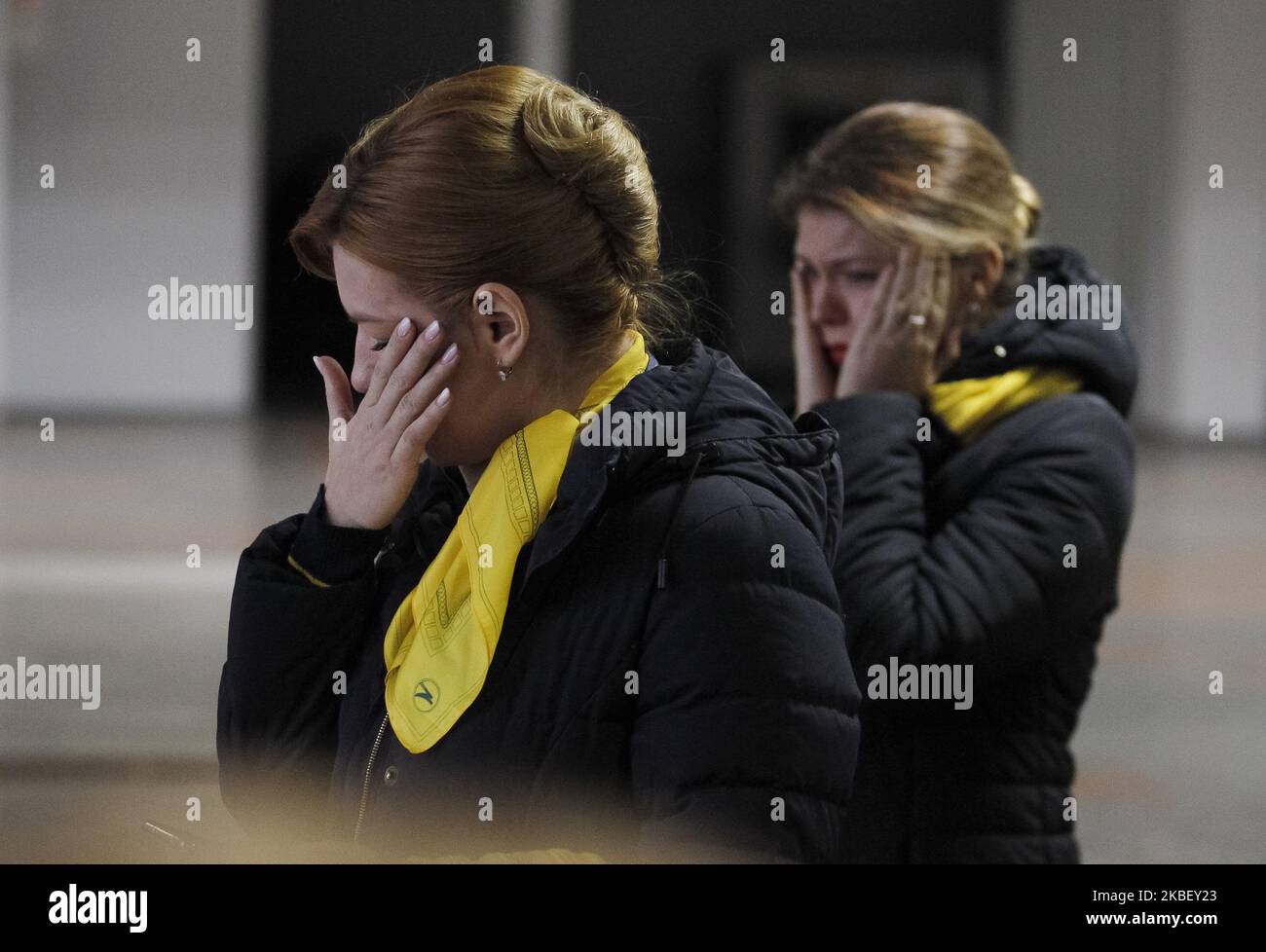 People react as coffins of 11 Ukrainians, crew members and passengers the Ukrainian 737-800 plane crash in Iran, arrive for memorial service to the Boryspil Airport near Kiev, Ukraine, on 19 January, 2020. The bodies of Ukrainians, 9 crew members of the Ukraine International Airlines (UIA) and 2 passengers, dead the plane crash in Iran, were handed over from Iran to Ukraine. (Photo by STR/NurPhoto) Stock Photo