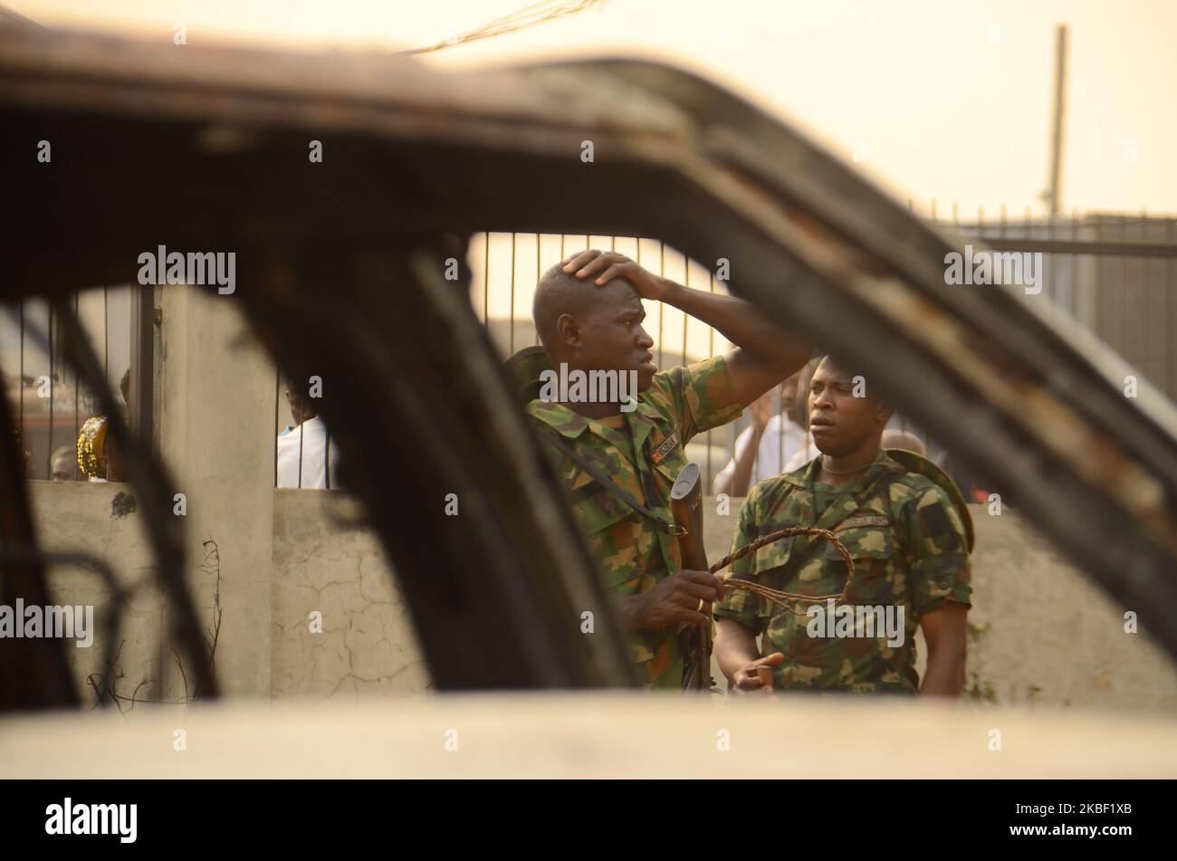A man of the Nigerian military officer Woman reacts to destruction and the sight of burnt bodies at the scene of a gas pipeline explosion that rocked the Ekoro area of Abule-Egba, Lagos State, on Sunday, January 19, 2020. Five people were killed, 39 vehicles razed, and several shops and 150 people displaced in Lagos pipeline explosion after thieves breached a fuel pipeline in Lagos, Nigeria's commercial hub, causing an explosion. (Photo by Olukayode Jaiyeola/NurPhoto) Stock Photo