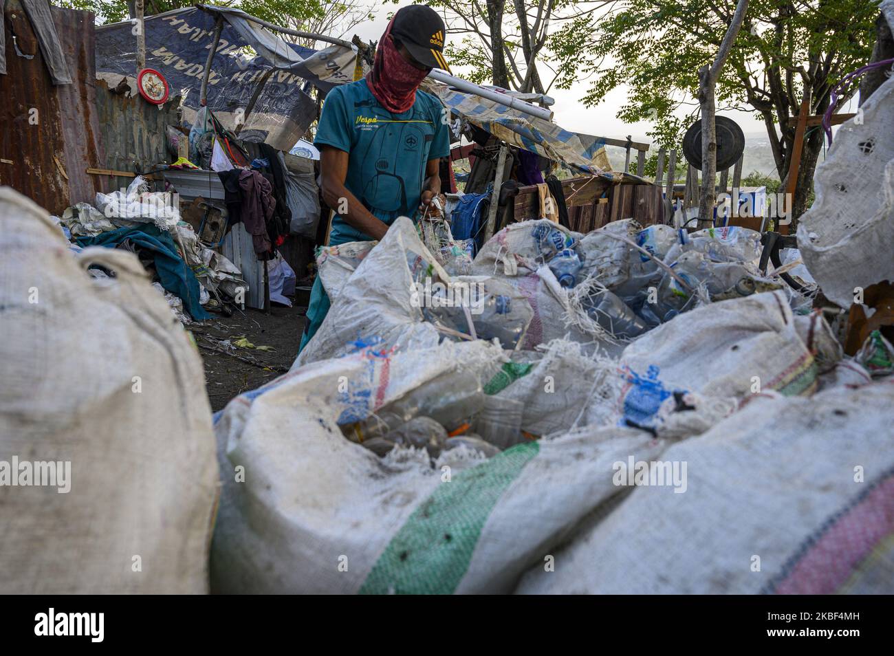 A scavenger sorts out the plastic waste he collects for recycling at the Kawatuna landfill, Palu, Central Sulawesi, Indonesia on January 22, 2020. The economic potential for recycling plastic waste is huge because based on the results of an environmental audit by Greenpeace in 2019, only 9 percent of the waste plastic is recycled, 12 percent is burned and 79 percent ends up in landfills and waterways like rivers that run into the ocean. Indonesia is the second largest waste producer in the world after China. (Photo by Basri Marzuki/NurPhoto) Stock Photo