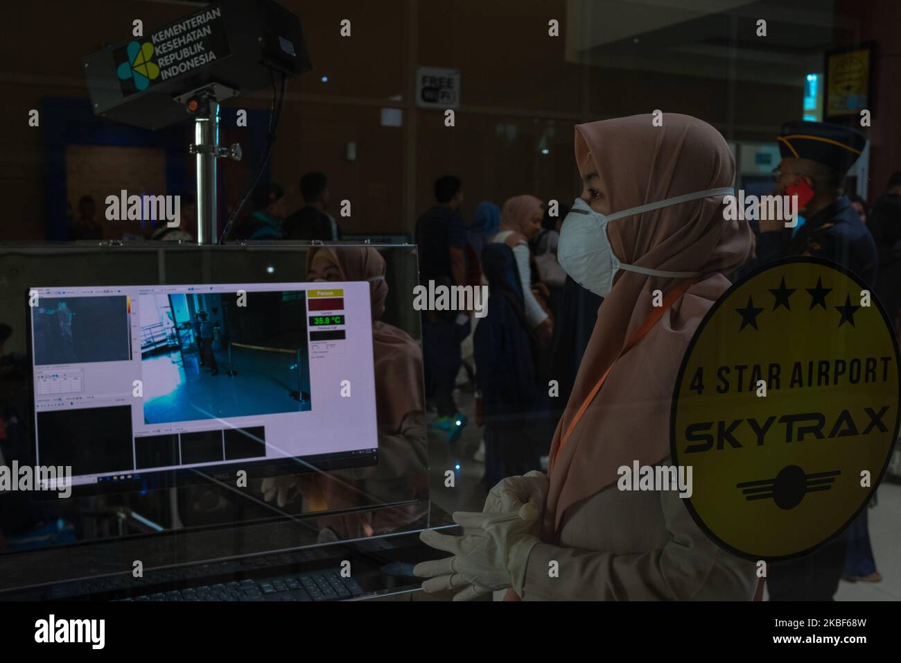 A health worker monitors a thermal scanner as passengers arrive at Sultan Syarif Kasim II airport on January 23, 2020 in Pekanbaru, Indonesia. A new virus that has killed nine people, infected hundreds and already reached the United States could mutate and spread, China warned January 21, as authorities scrambled to contain the disease during the Lunar New Year travel season. (Photo by Afrianto Silalahi/NurPhoto) Stock Photo
