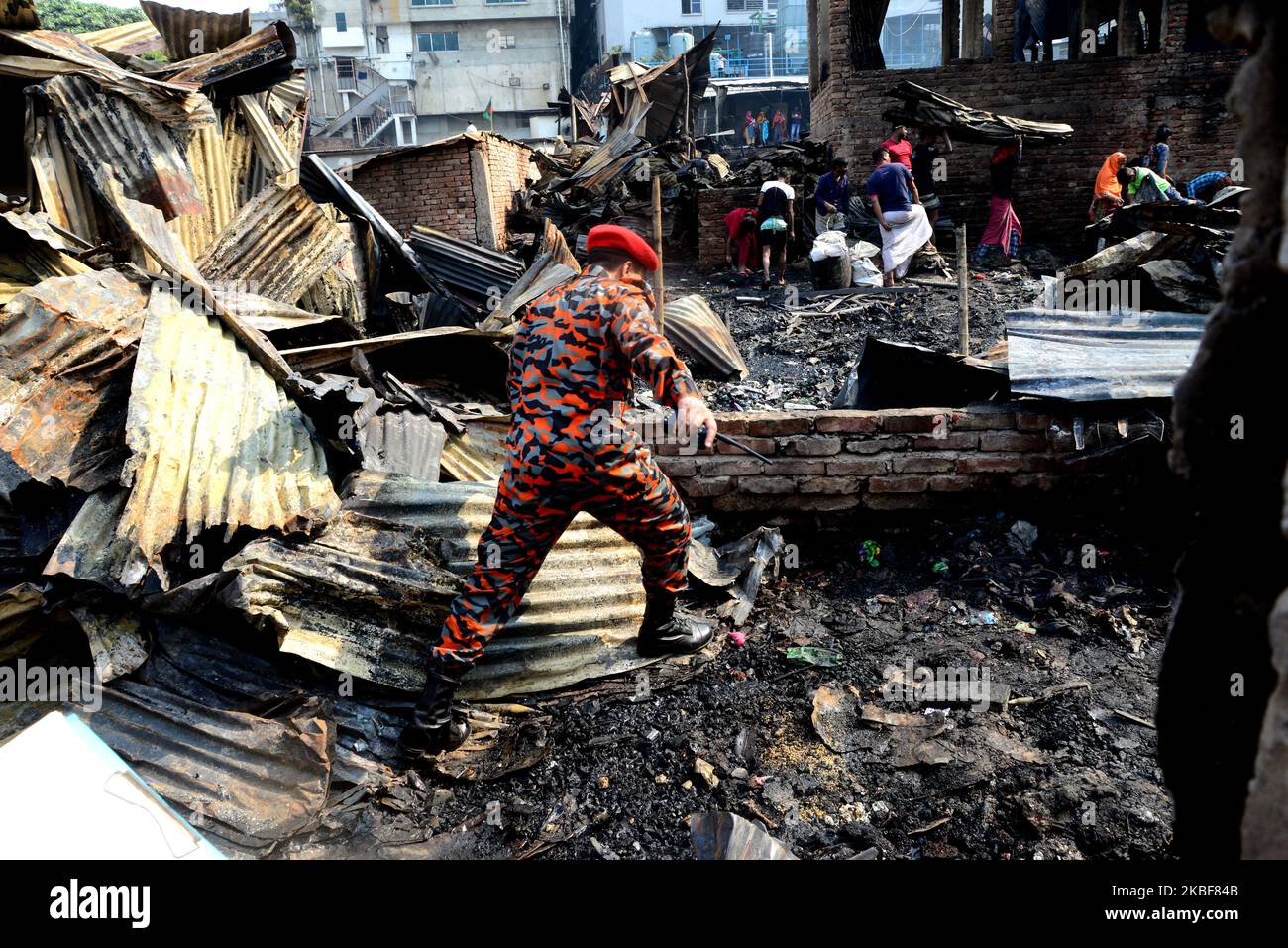 Bangladeshi firefighters seen searching after a devastating fire that ...