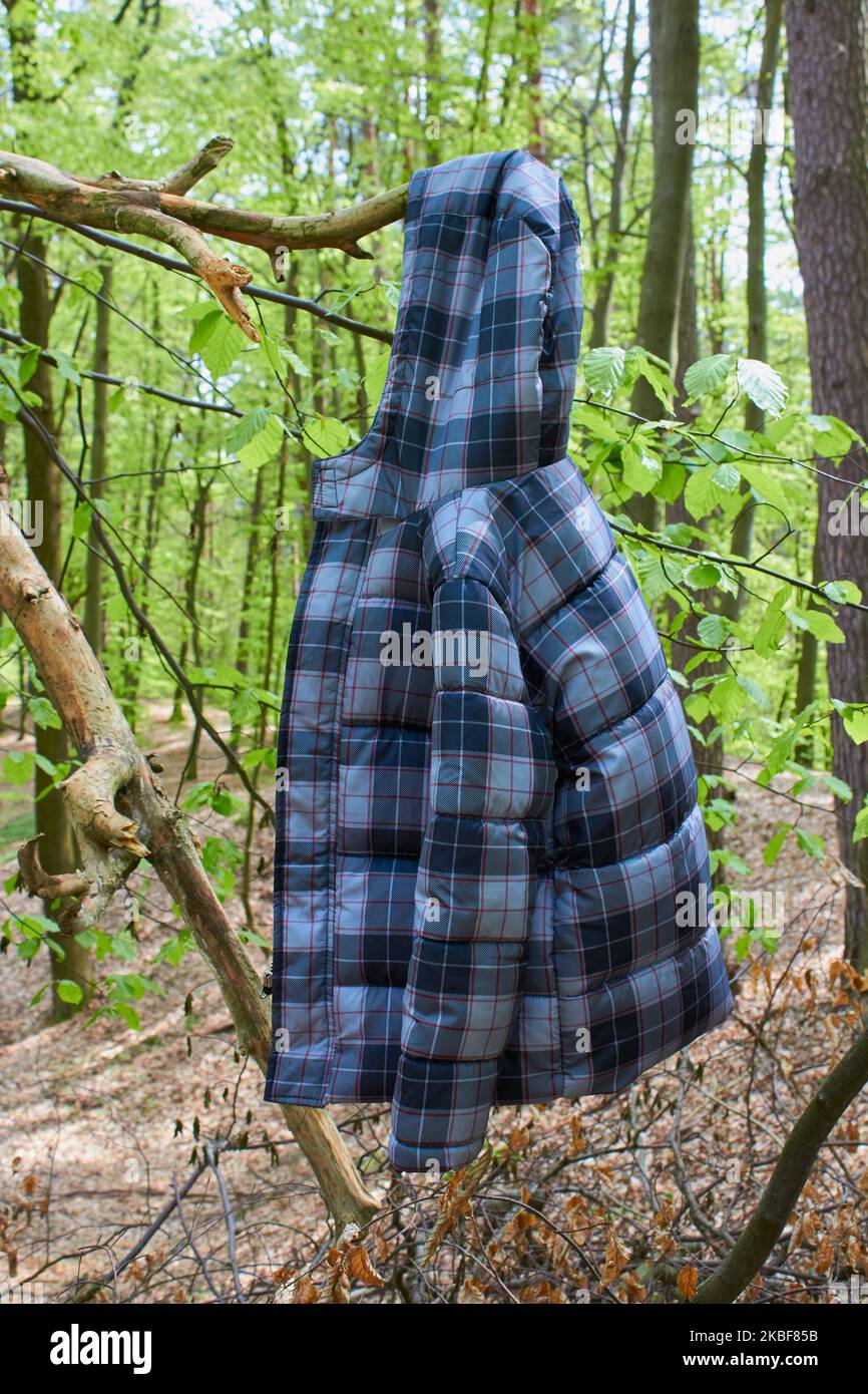 on a branch hangs a winter children's jacket Stock Photo