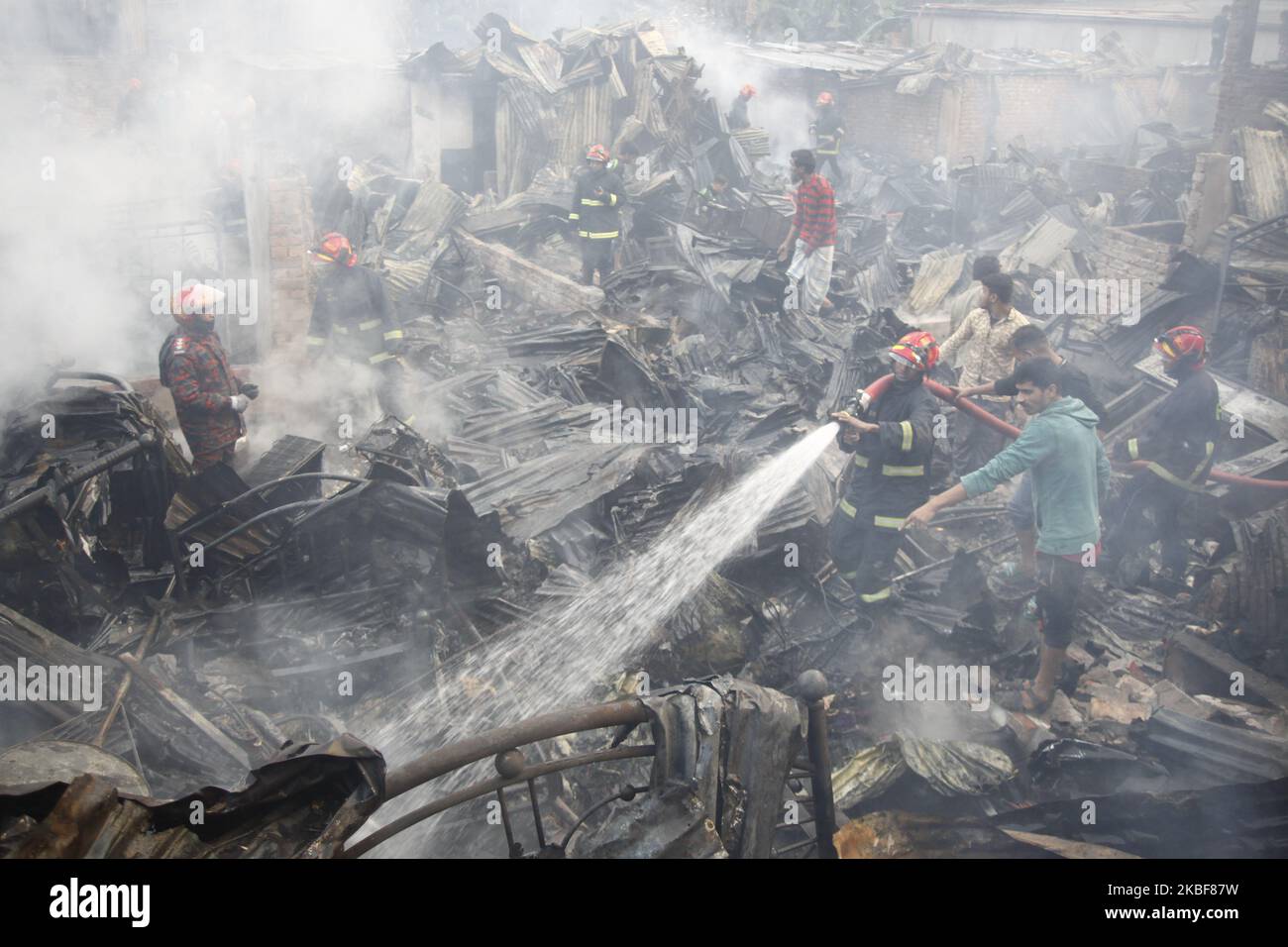 Bangladeshi firefighters extinguish a fire that broke out at Chalantika ...