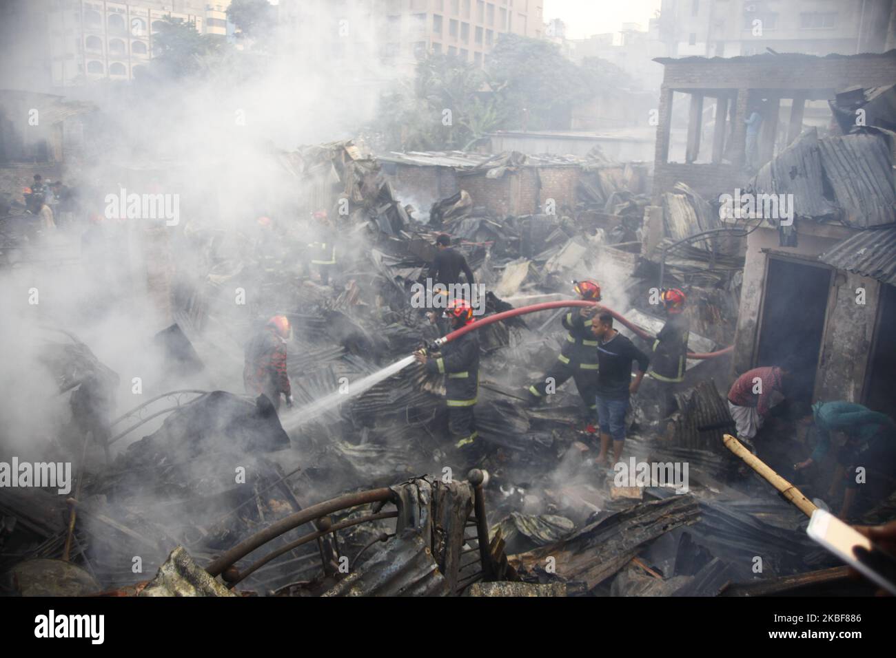 Bangladeshi firefighters extinguish a fire that broke out at Chalantika ...
