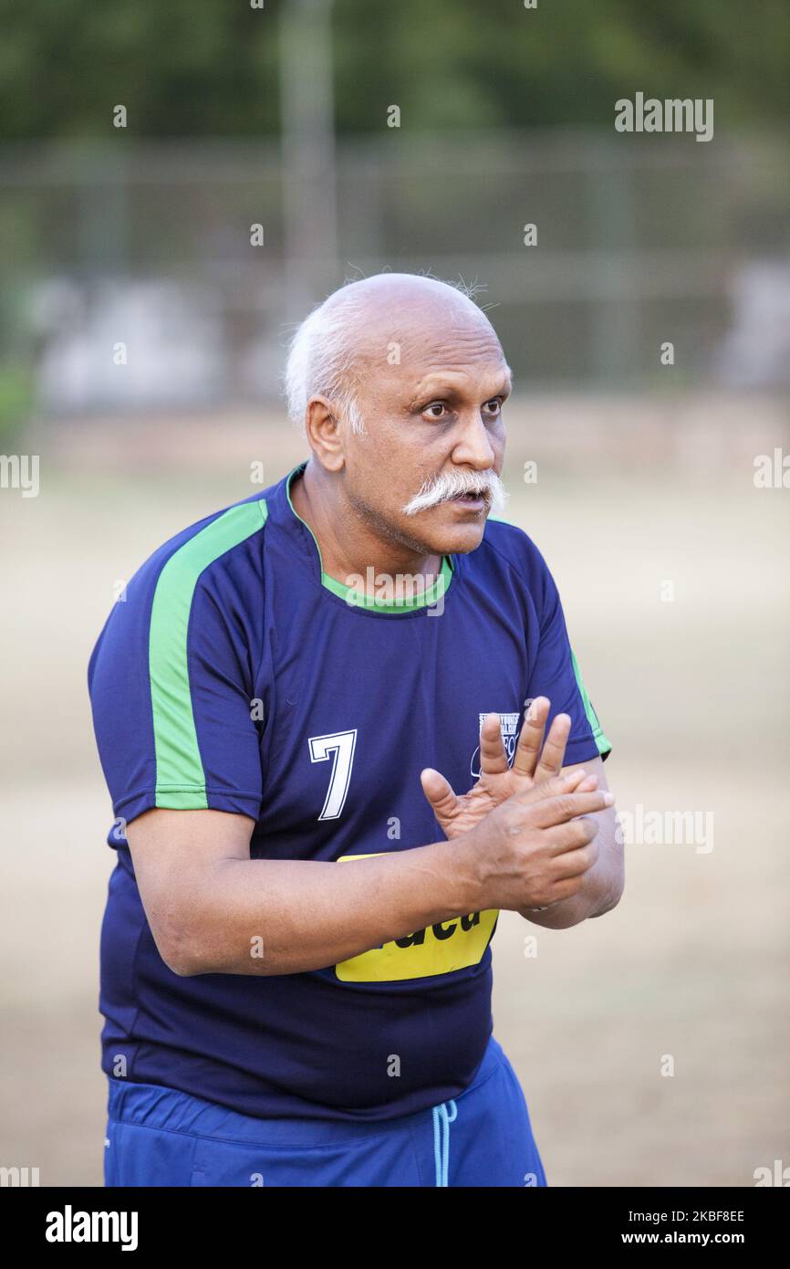 Training of FC Simla Youngs football club in Delhi, India on 2 April, 2018. Coach Tushar Dev gives instruction to players. The conditions in India for top football (soccer) are difficult. The heat - the season in lower competitions is only two months, ie in March and April. Poor surfaces and smog are also problematic. Simla Youngs is a club that was founded in 1936 and is one of the most traditional in India. Recently, clubs like Barcelona Gurgaon, Paris Saint Germain started to open their soccer academies, fees at such academies are not cheap. Trainers come from Europe for trainings, world ch Stock Photo