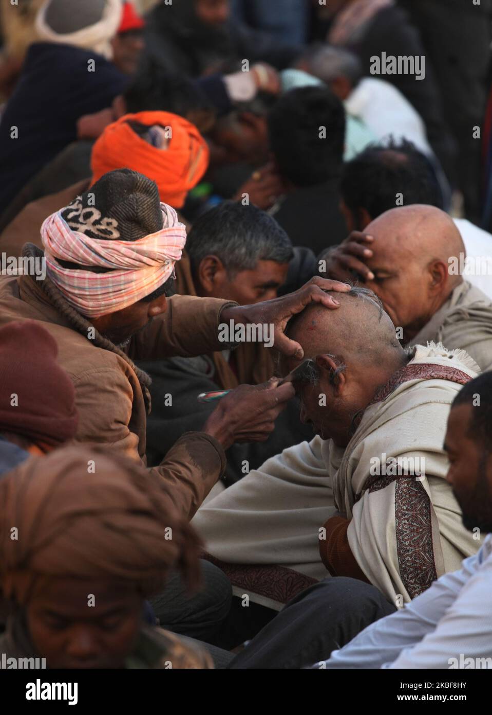 devotees get shave outside their camps before taking holy dip at at sangam , confluence of Ganga , Yamuna and mythological Saraswati rivers , on the auspicious holy bathing day of Mauni Amavasya in Allahabad on January 24 , 2020 . (Photo by Ritesh Shukla ) (Photo by Ritesh Shukla/NurPhoto) Stock Photo
