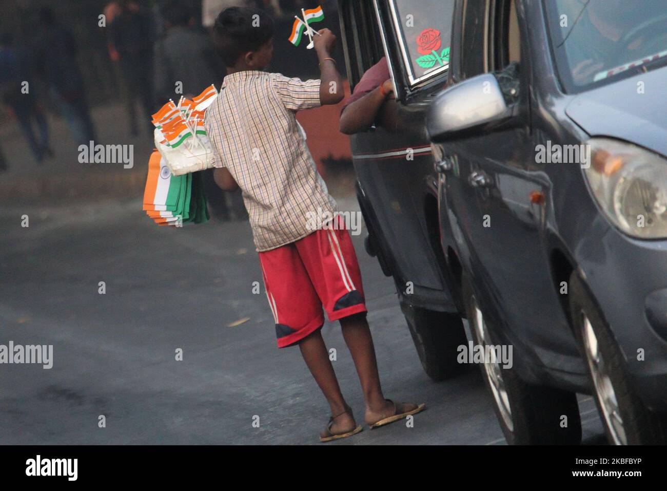 A boy sells Indian tricolour flags on the eve of country's 71st Republic Day at a traffic intersection in Mumbai, India on 26 January 2020. (Photo by Himanshu Bhatt/NurPhoto) Stock Photo