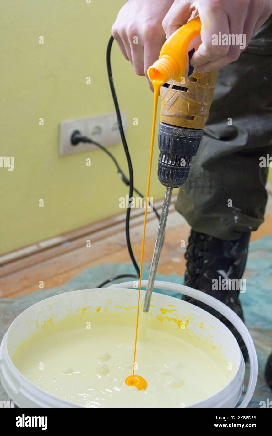 Pouring Paint Into A Bucket