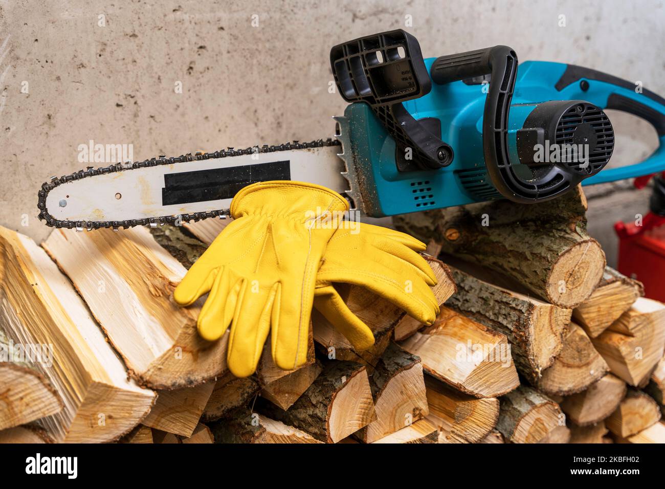 electric chain saw and protective leather work gloves Stock Photo