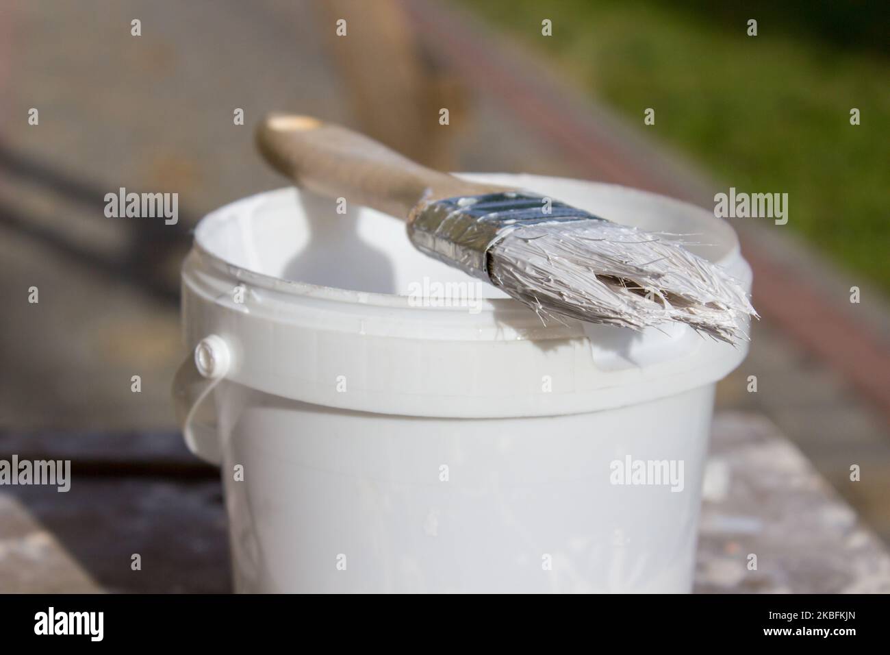 Paint brush resting on paint tin viewed from above Stock Photo