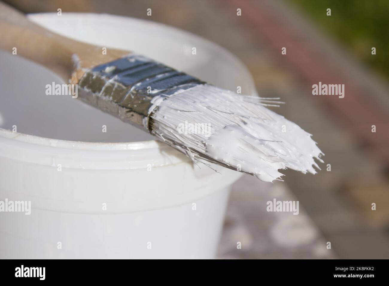 Paint brush resting on paint tin viewed from above Stock Photo