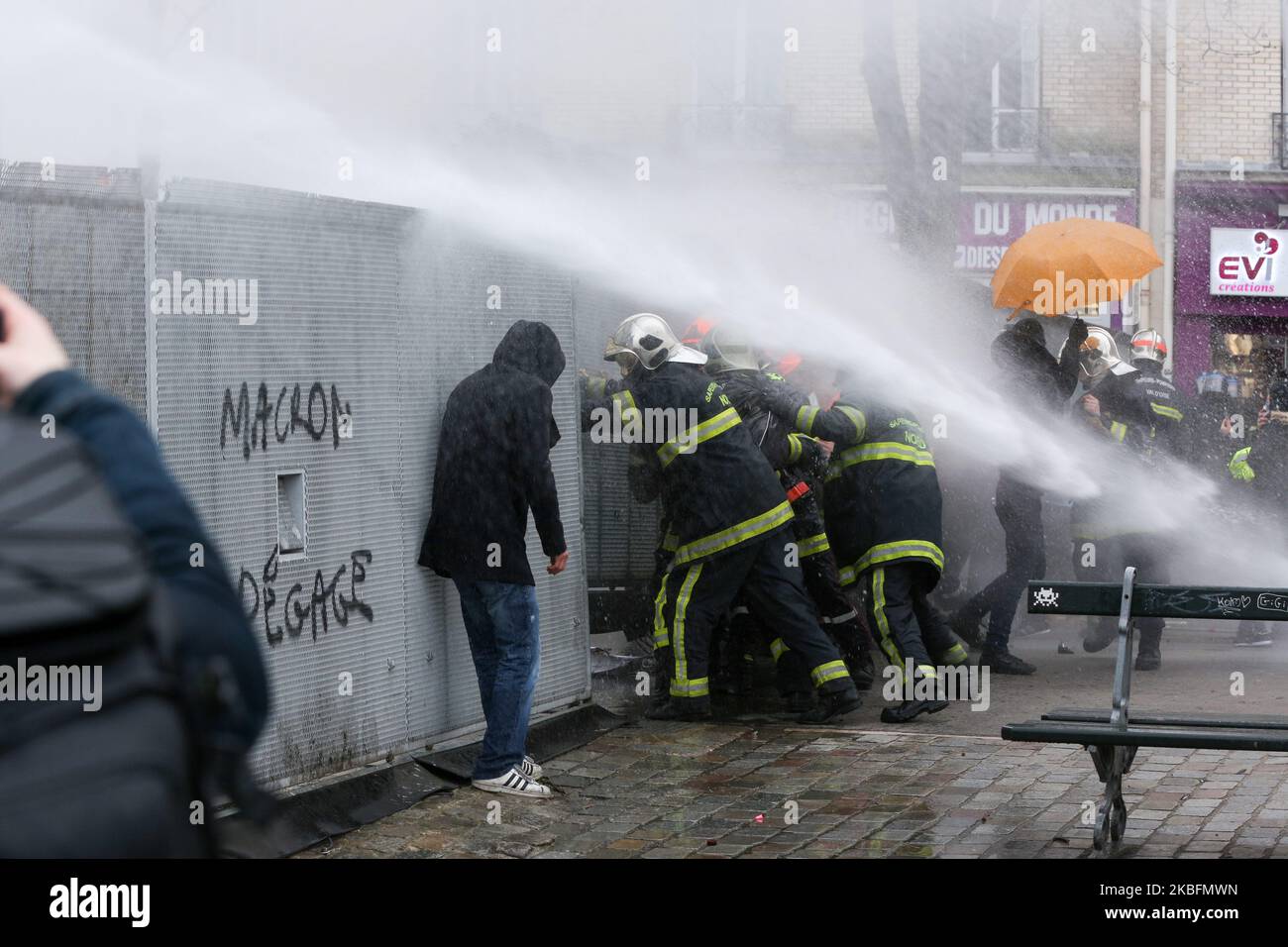 Firefighters try to open a path in a riot barricade and were repelled by water canons during a demonstration to protest against French government's plan to overhaul the country's retirement system in Paris, on January 28, 2020. (Photo by Michel Stoupak/NurPhoto) Stock Photo