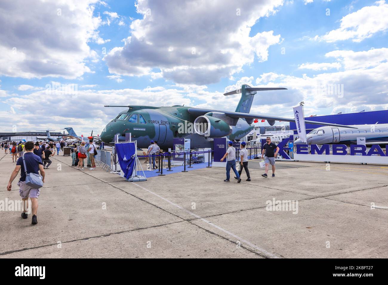 Crowd of visitors at the tarmac of Le Bourget Airport during Paris Air Show 2019 and the Brazilian Air Force Embraer KC-390 renamed after Boeing and Embraer deal as C-390 Millennium, the made in Brazil medium sized transport aircraft as seen on 53rd Paris Air Show Le Bourget in France on June 21, 2019. It is made by Brazilian aerospace manufacturer Embraer Defense and Security with its first flight on February 3, 2019. The military multipurpose airplane for cargo, aerialrefueling and troops can carry 26 tonnes in its fuselage and the 2x IAE V2500 jet engines. The aircraft registration is PT-ZN Stock Photo