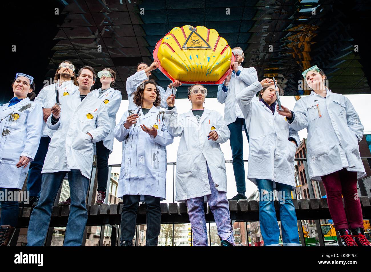 Activists are throwing fake oil on the floor during a Shell must fall