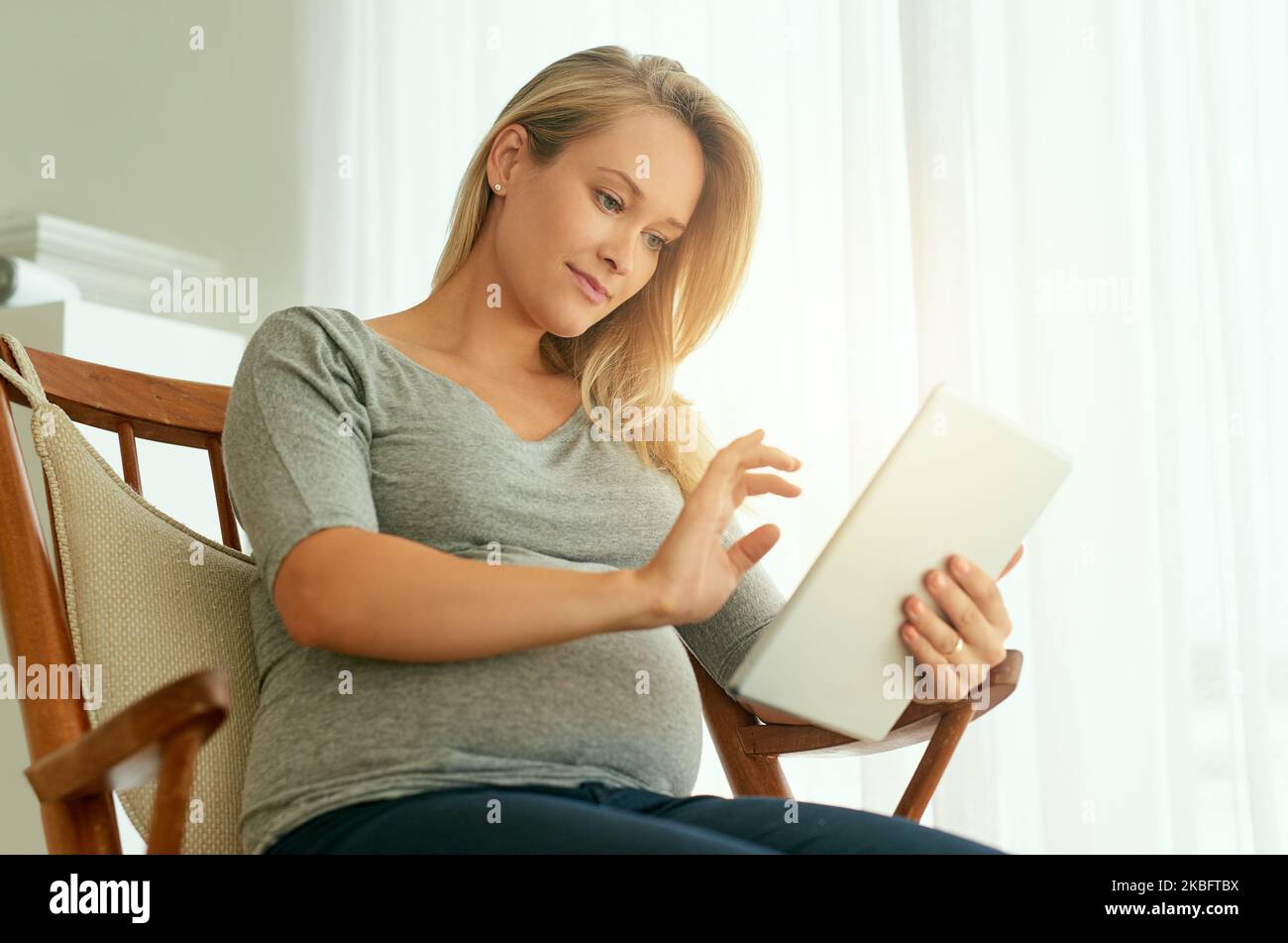 Getting a better understanding of her pregnancy. a pregnant woman using
