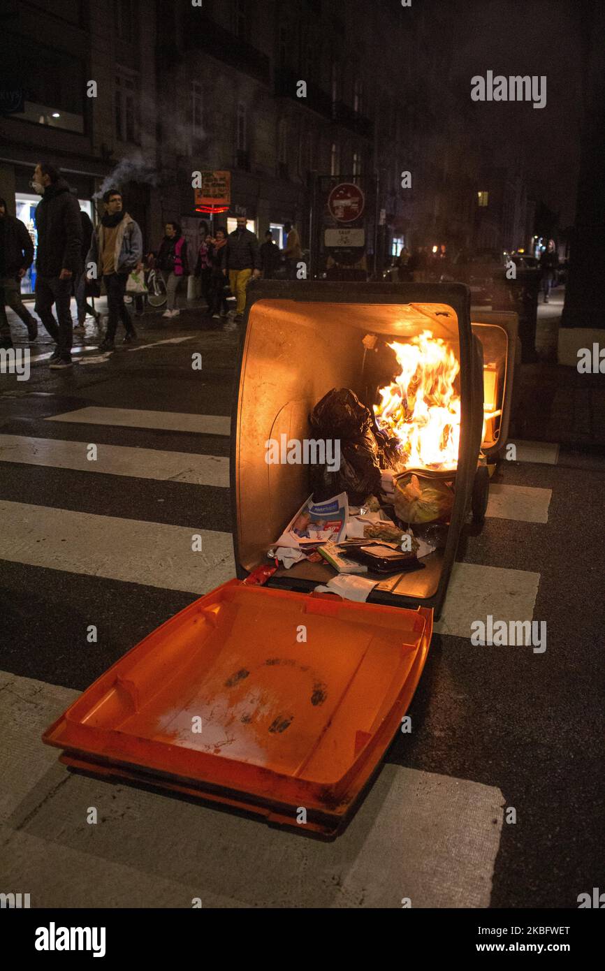 A trash can was set on fire during a torchlight demonstration against retirement reform on 30th January 2020 in Rennes. Trade unionists followed the demonstration calmly while several groups of thugs clashed with the police on several occasions. Several charges and tear gas canisters were fired by the police. At the end of the demonstration a car was set on fire before the crowd dispersed. (Photo by Antoine Cheville/NurPhoto) Stock Photo