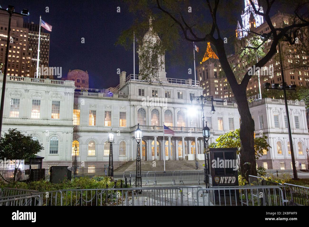 New York City Hall circa 1812 government complex, the seat of NYC government and office of the mayor, city council, located at the center of City Hall Park in the Civic Center area of Lower Manhattan, between Broadway, Park Row, and Chambers Street as seen illuminated at night. The historic building with exterior French Renaissance Revival architectural style is the oldest city hall in the United States that still houses its original governmental functions. NY, USA (Photo by Nicolas Economou/NurPhoto) Stock Photo