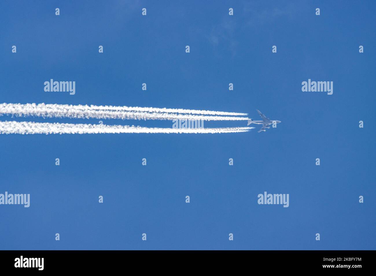 Lufthansa Boeing 747 commercial airplane overfly forming engine exhaust contrails behind in high altitude in the blue sky. The iconic double-decker Jumbo Jet nicknamed Queen of the Skies is flying at 34.000 feet on 29 January 2020 over the Netherlands as it is flying a trans-Atlantic route from Frankfurt FRA airport in Germany to Toronto, YYZ, Canada, flight LH470 / DLH470. The overflying aircraft is a Boeing 747-430, B744 with registration D-ABVX and speed 726km/h or 392 kts (knots). Lufthansa is the flag carrier of Germany and a Star Alliance member. (Photo by Nicolas Economou/NurPhoto) Stock Photo