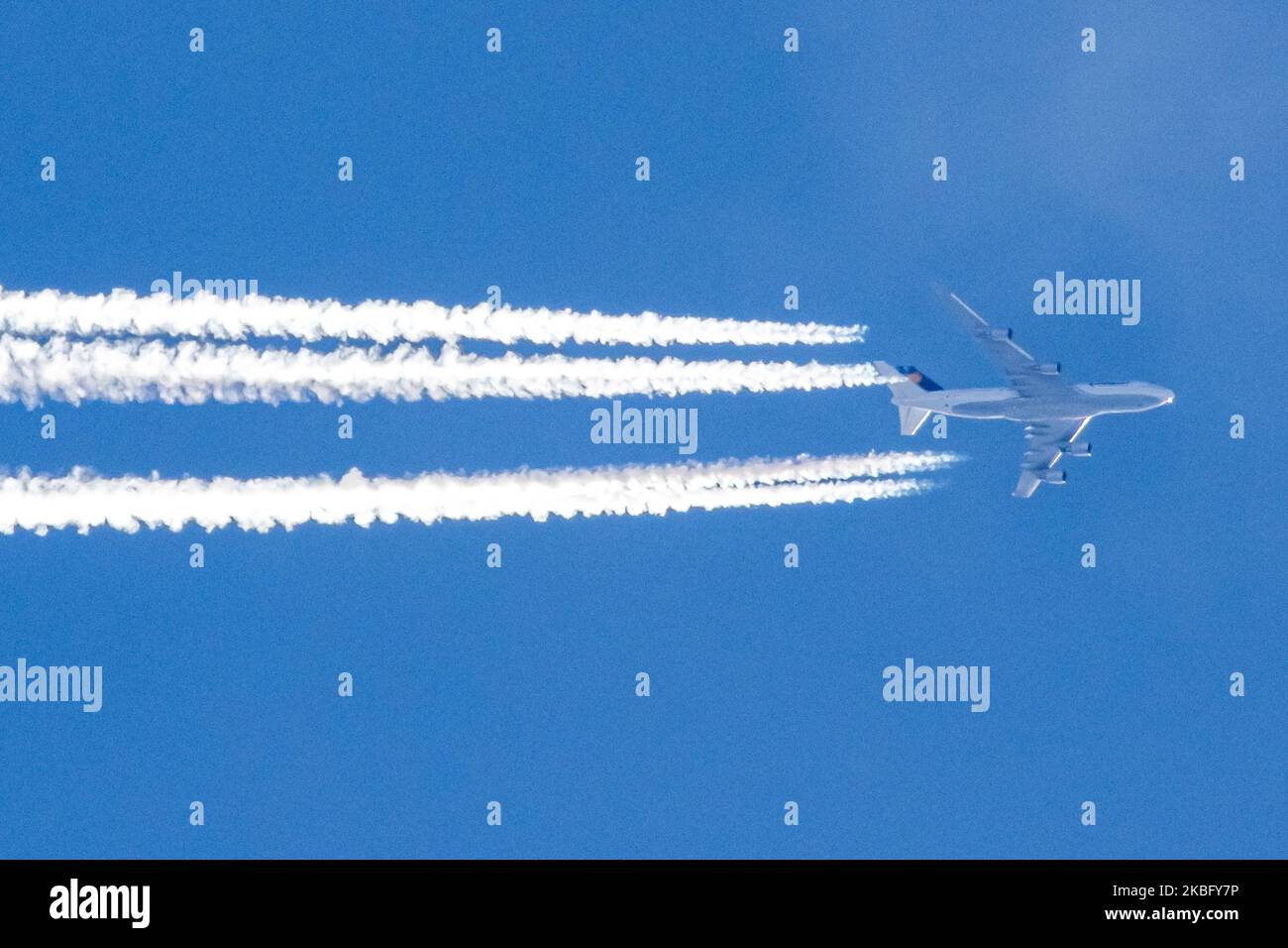 Lufthansa Boeing 747 commercial airplane overfly forming engine exhaust contrails behind in high altitude in the blue sky. The iconic double-decker Jumbo Jet nicknamed Queen of the Skies is flying at 34.000 feet on 29 January 2020 over the Netherlands as it is flying a trans-Atlantic route from Frankfurt FRA airport in Germany to Toronto, YYZ, Canada, flight LH470 / DLH470. The overflying aircraft is a Boeing 747-430, B744 with registration D-ABVX and speed 726km/h or 392 kts (knots). Lufthansa is the flag carrier of Germany and a Star Alliance member. (Photo by Nicolas Economou/NurPhoto) Stock Photo