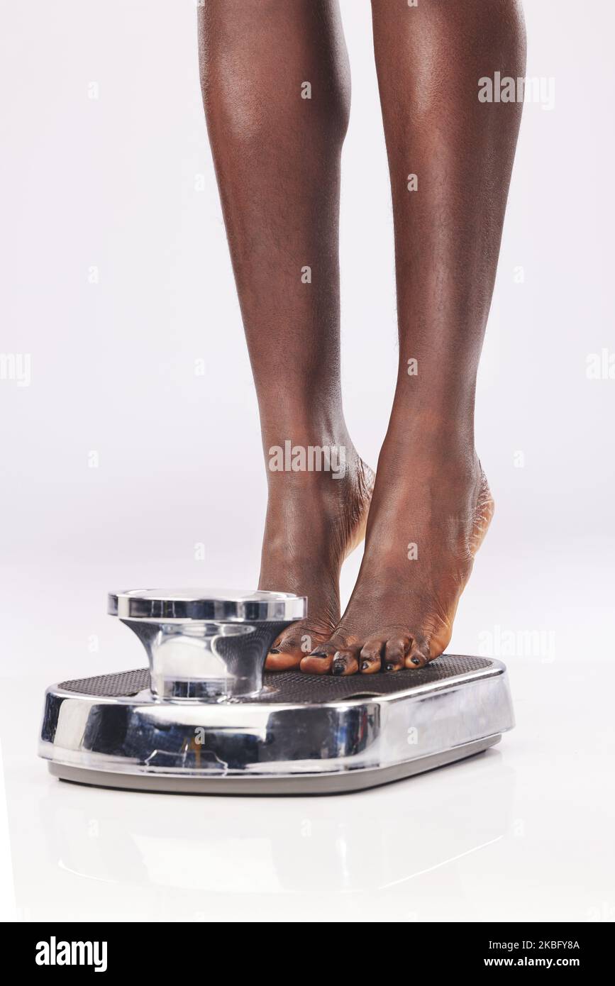 https://c8.alamy.com/comp/2KBFY8A/black-woman-feet-and-scale-to-measure-weight-diet-and-weightloss-against-a-white-studio-back-with-mockup-foot-health-and-wellness-with-female-2KBFY8A.jpg