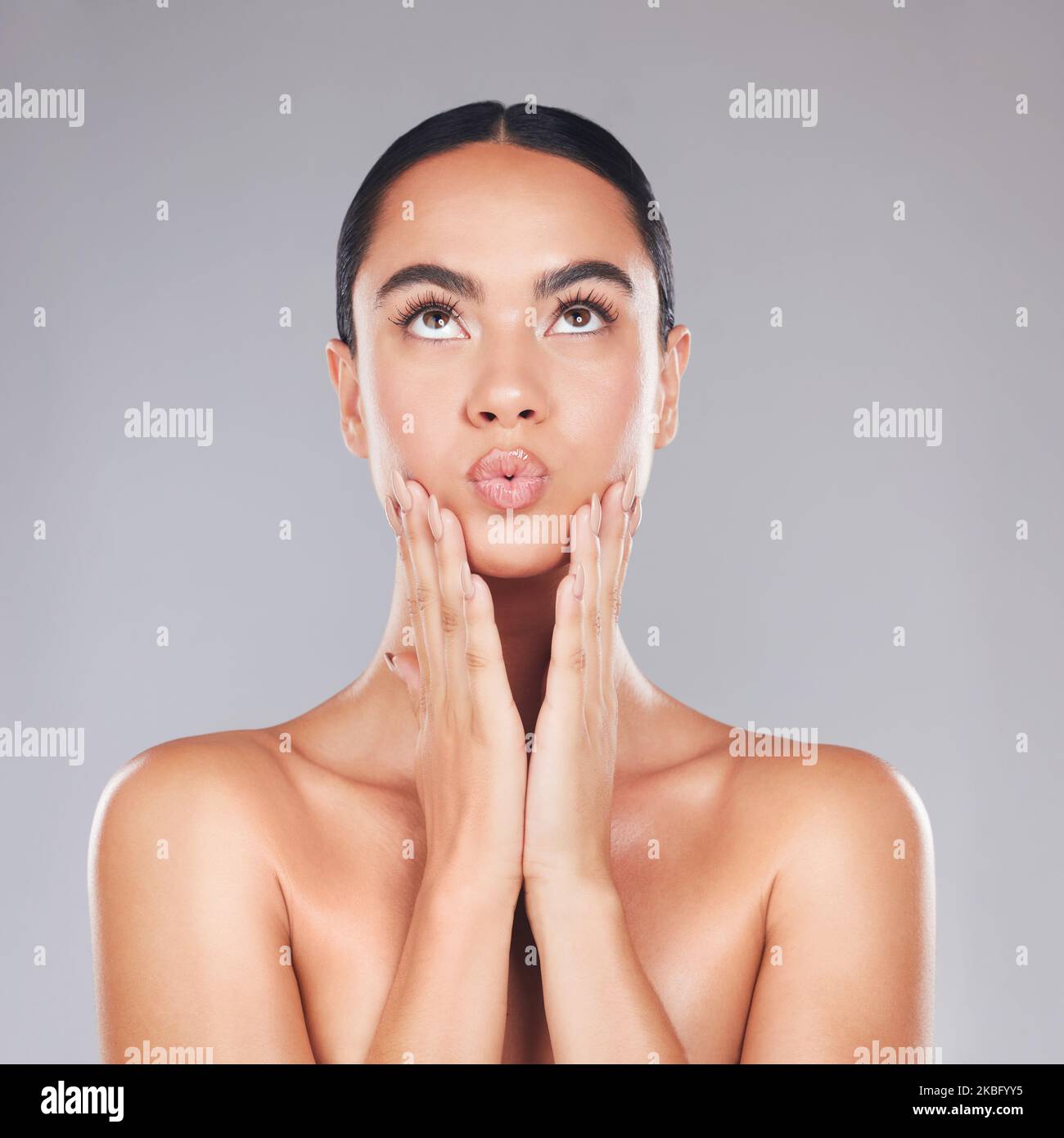 Skincare, beauty and surprise face of a woman from Spain with healthy, wellness and glowing skin. Female model hands after cosmetic, health Stock Photo
