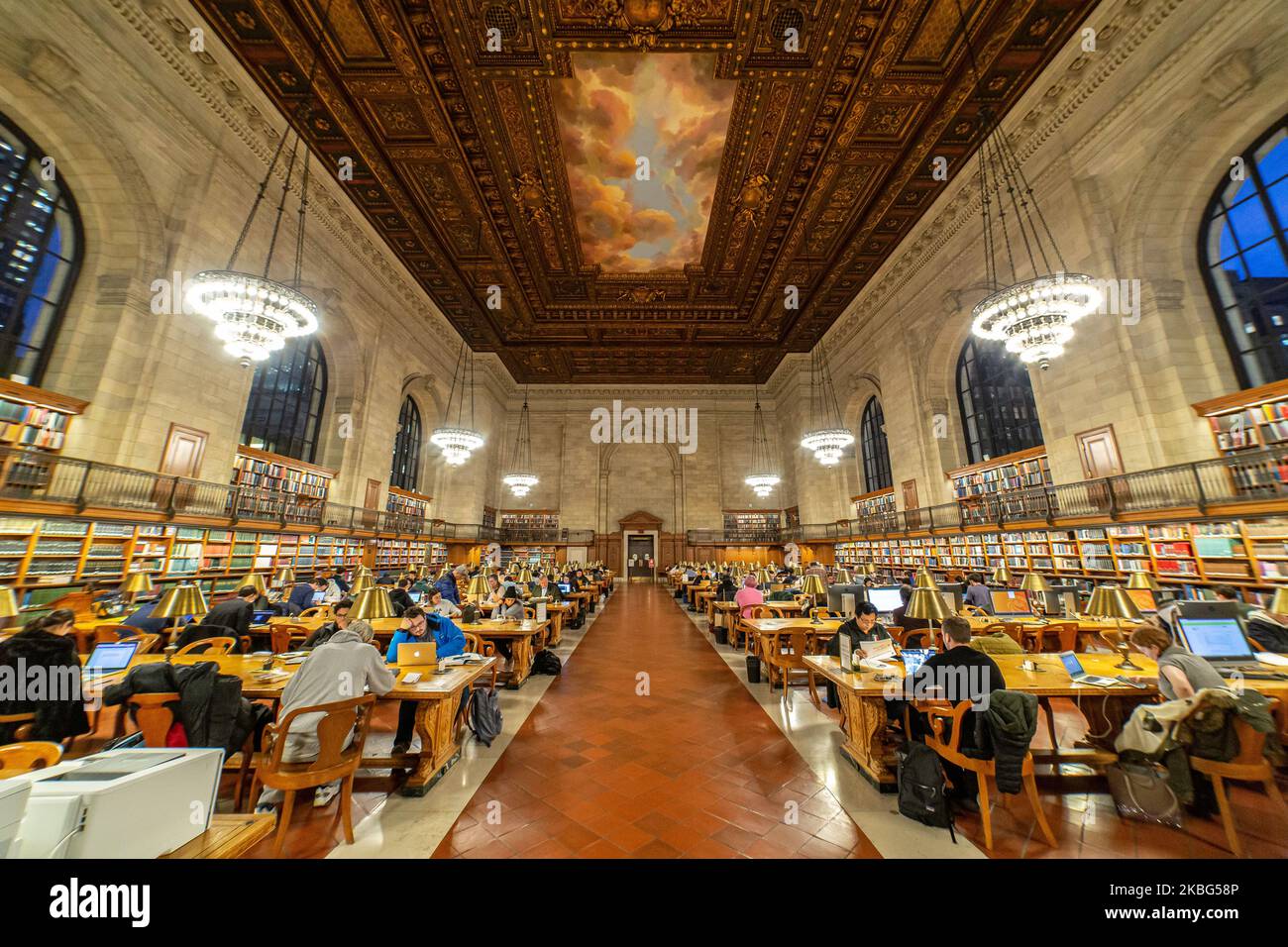 Inside the Rose Main Reading Room, the main reading room with side books and large windows, officially Room 315 on the third floor, a room 78 x 297 feet and 52 foot high wooden carved ceiling in a style between Renaissance architectural style and Beaux-Arts design in the Stephen A. Schwarzman Building, commonly known as the Main Branch. New York Public Library Main Branch in Bryant Park, Manhattan, NYPL, is the third largest library in the world. The branch was declared a National Historic Landmark in 1965 and designated a New York City Landmark in 1967. The research library was opened to publ Stock Photo