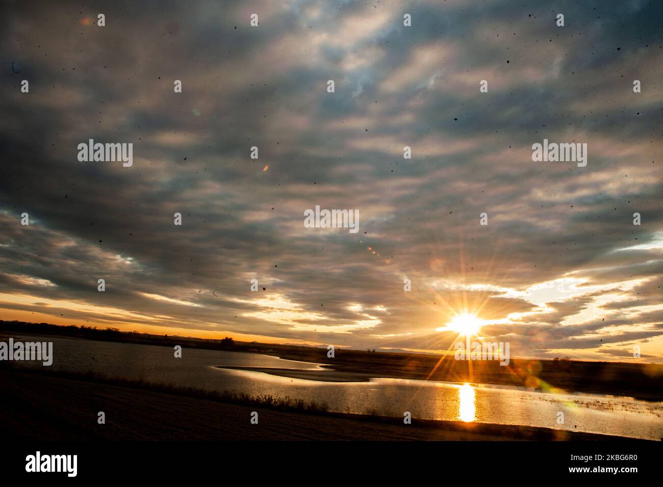 Sunset is seen over a little dam near the city of Dimitrovgrad, Bulgaria on February 03, 2020 (Photo by Hristo Rusev/NurPhoto) Stock Photo