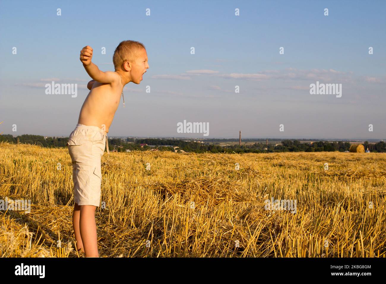 standing in the field boy and shouting and hands in the sides Stock ...