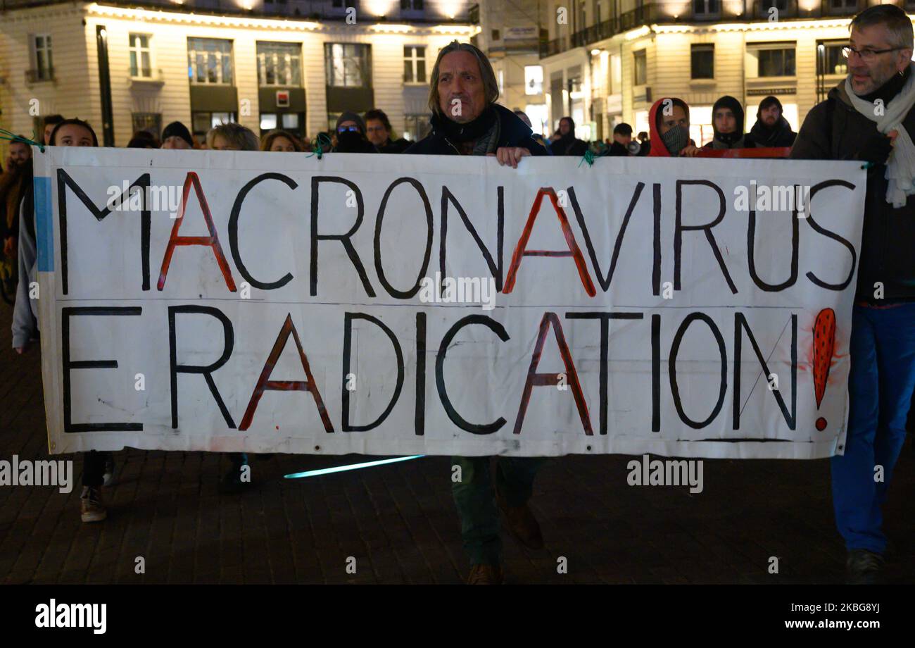 Banner making the analogy between the policies of Emmanuel Macron and the epidemic of Coronavirus during a far-left demonstration in Nantes, France on February 4, 2020. (Photo by Estelle Ruiz/NurPhoto) Stock Photo