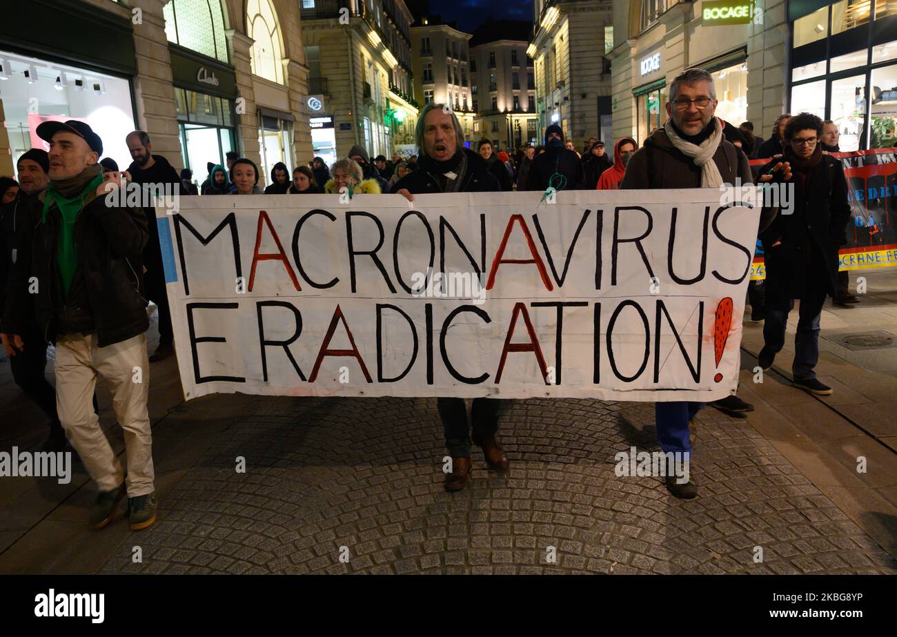 Banner making the analogy between the policies of Emmanuel Macron and the epidemic of Coronavirus during a far-left demonstration in Nantes, France on February 4, 2020. (Photo by Estelle Ruiz/NurPhoto) Stock Photo