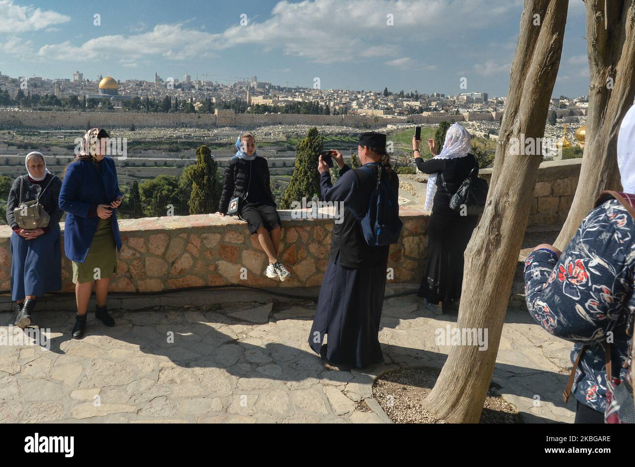 Pilgrims take pictures with a view of the Old City of Jerusalem with its Dome of the Rock mosque in the centre, seen from the Mount of Olives. On Wednesday, February 5, 2020, in Jerusalem, Israel. (Photo by Artur Widak/NurPhoto) Stock Photo