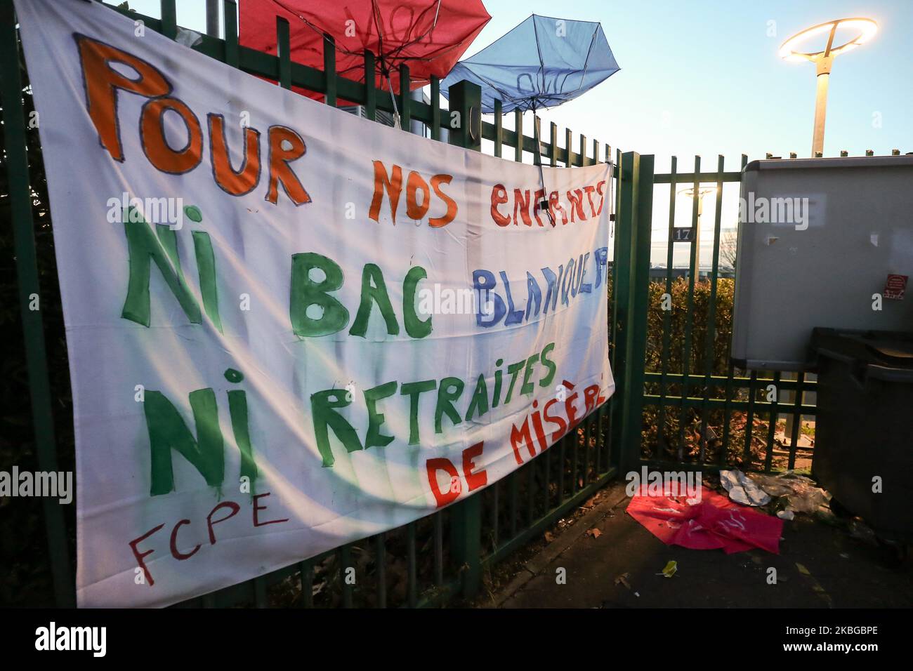 Student’s families opposed to the implementation of the baccalaureate reform (E3C) are putting up a banner reading « For our children, neither minister’s bacalaureate, nor meagre pension » on the front gate of the Lycee Jean Macé, located in Vitry-sur-Seine, in the southern suburbs of Paris, on 6 February 6, 2020.The demonstration took place in a ninth inter-professional day of strikes and demonstrations since early December 2019 against the French government's pensions overhaul. (Photo by Michel Stoupak/NurPhoto) Stock Photo