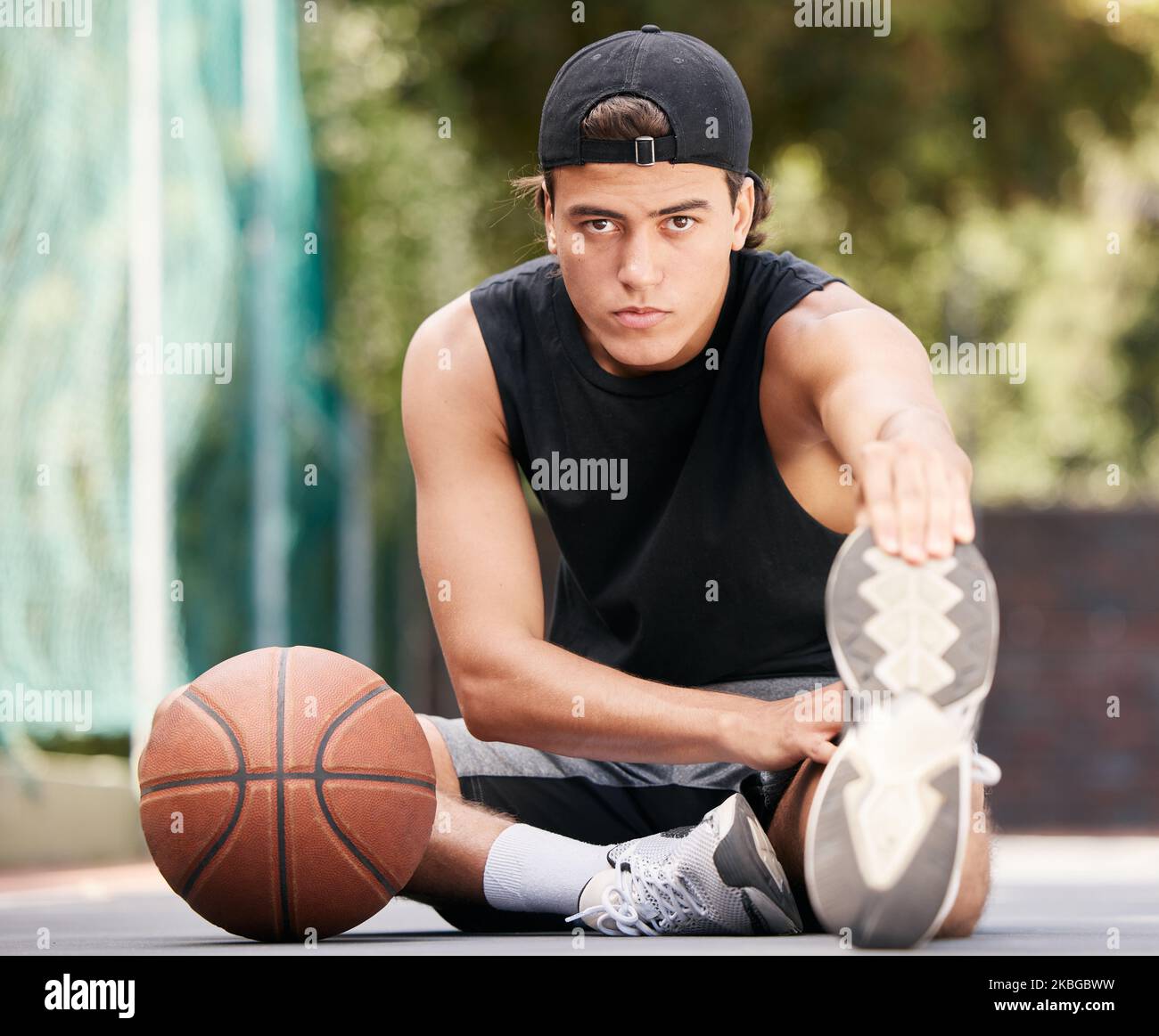 Portrait, basketball and man stretching legs for flexibility, wellness or mobility. Sports