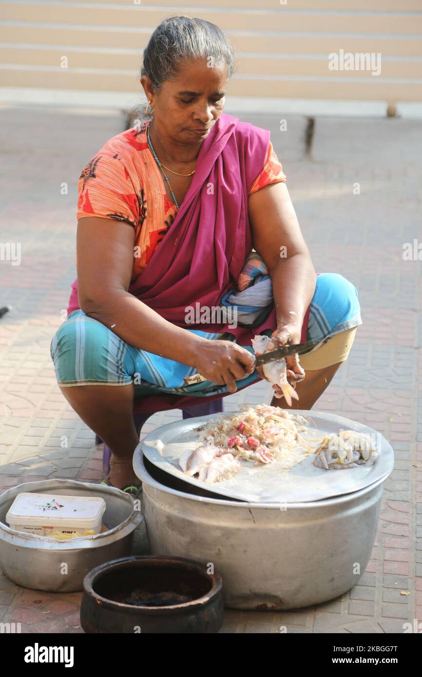 Door fish seller cuts fresh fish hires stock photography and images