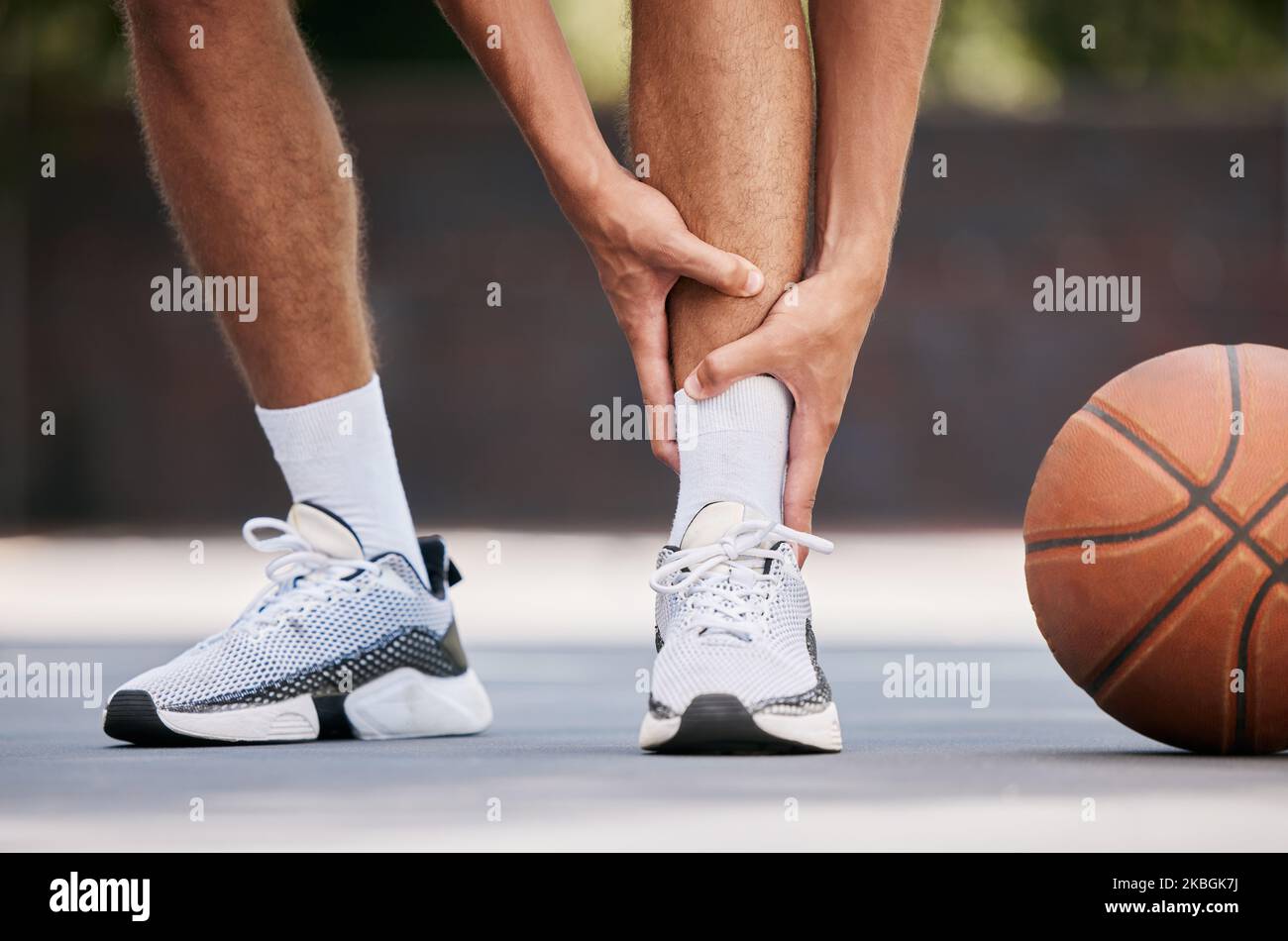 Legs, pain and sport injury with basketball and athlete on basketball court outdoor with