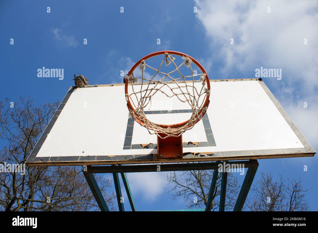 Picture of a basketball field goal with the sky in background. Stock Photo