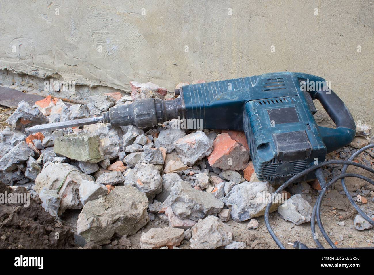 lying HammerDrill in the construction tool on a pile of bricks and