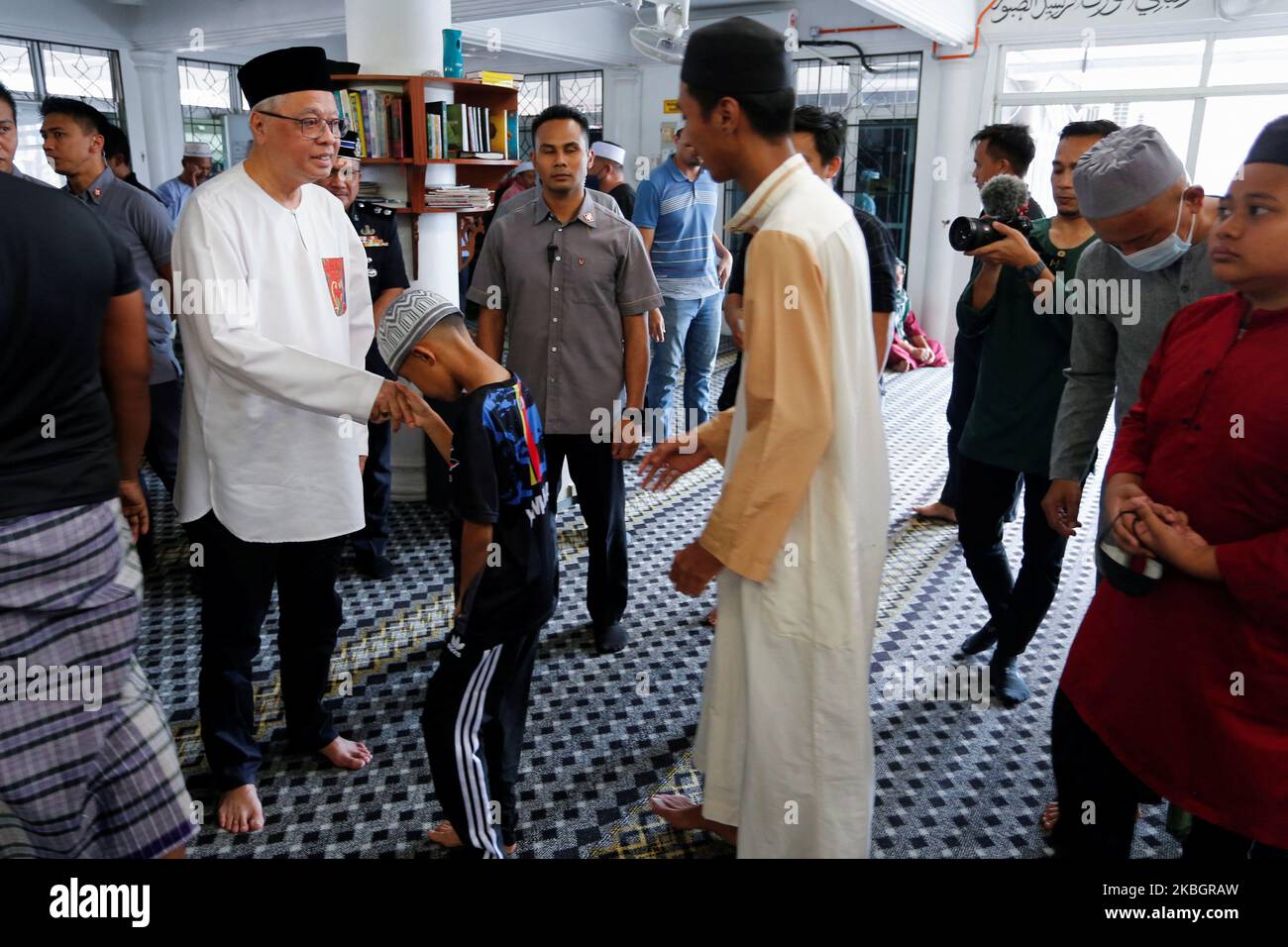 Malaysian Caretaker Prime Minister Ismail Sabri Yaakob shakes hands with local community members after Friday prayer, a day before the nomination day, in Bera, Pahang, Malaysia November 4, 2022. REUTERS/Lai Seng Sin Stock Photo