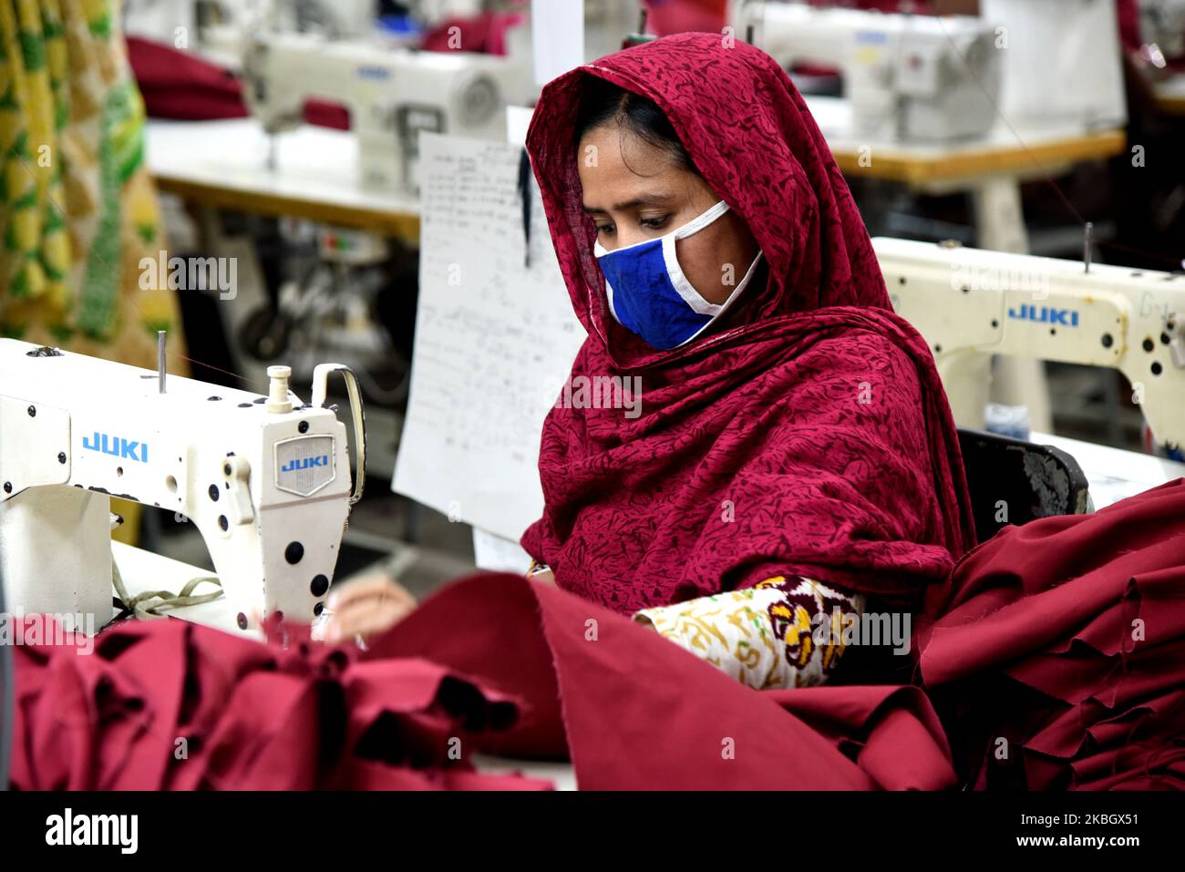 Bangladeshi worker works at a garment factory in Savar outskirts of Dhaka, Bangladesh, on February 13, 2020. The garment sector has provided employment opportunities to women from the rural areas that previously did not have any opportunity to be part of the formal workforce. This has given women the chance to be financially independent and have a voice in the family because now they contribute financially. However, women workers face problems. Most women come from low income families. Low wage of women workers and their compliance have enabled the industry to compete with the world market. Th Stock Photo