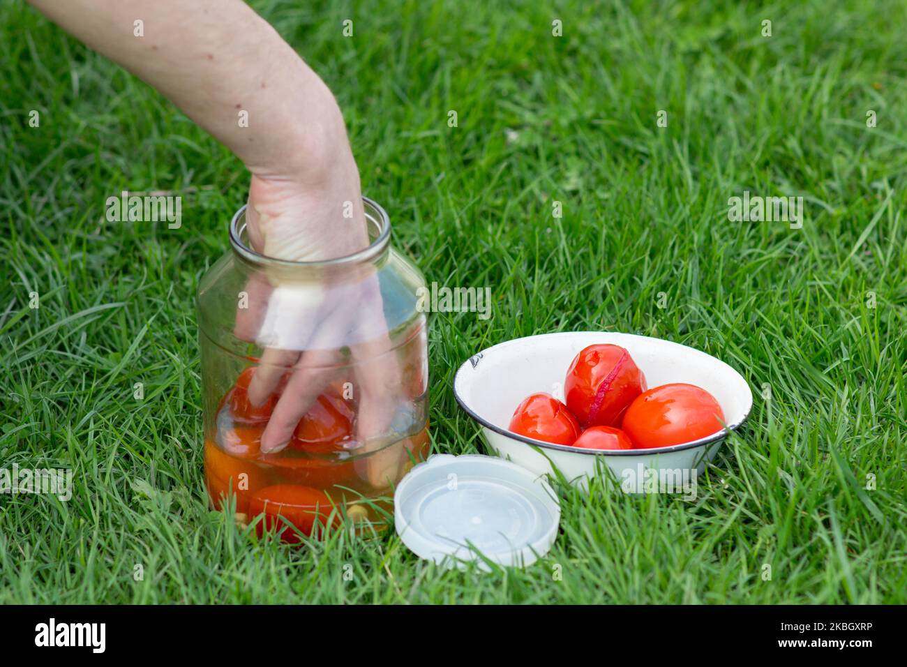 arm achieved with canned tomatoes with cans Stock Photo