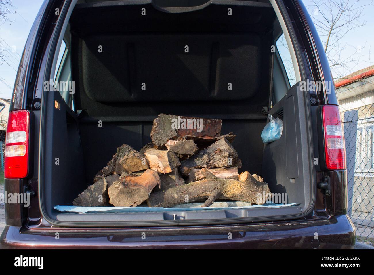 firewood for fire in the trunk of car Stock Photo