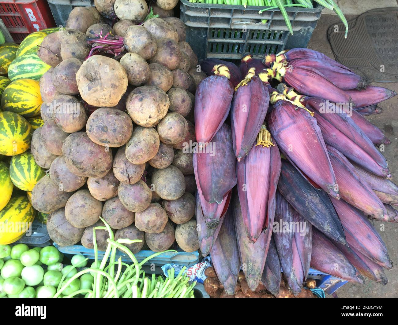 Banana plant flowers for sale at a produce market in Ambalmkulam