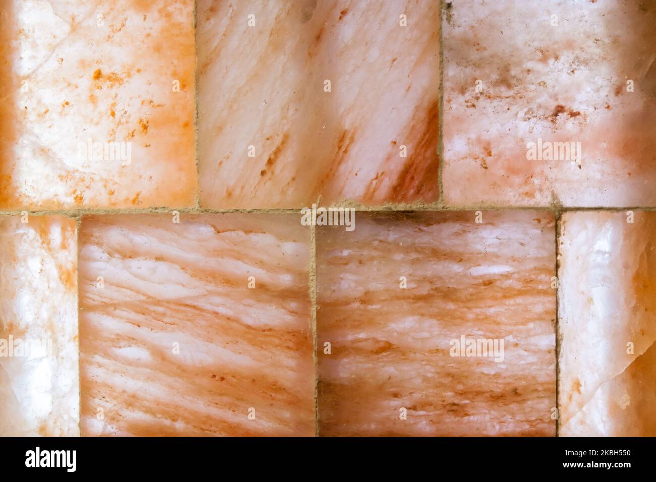 Background from a block of pink Himalayan salt in a salt room Stock