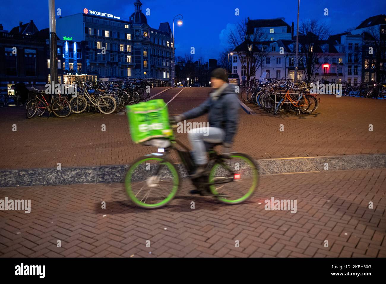 People using bikes in the city and/or electric car charging stations in Amsterdam seen on February 17, 2019. Amsterdam is equipped with an wide network of cycle-paths, so safe and comfortable that even toddlers and elderly people use bikes as the easiest mode of transport. Bikes are commonly used in other cities such as The Hague and Rotterdam. Gasoline and diesel fueled cars and motorcycles will be banned from Amsterdam from 2030 in an effort to clean up the city's air, the Dutch capital's council said in 2019. The use of electric vehicles is increasing in the city. A pass is needed to charge Stock Photo