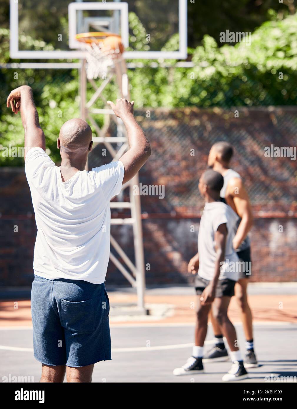 Basketball player, score and point in sports game for goal, victory or winning throw at the court outdoors. Man in basketball sport playing, scoring Stock Photo