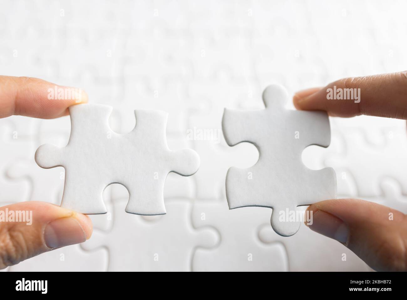 Closeup hand of man connecting jigsaw puzzle with sunlight effect, Business  solutions, success and strategy concept Stock Photo - Alamy