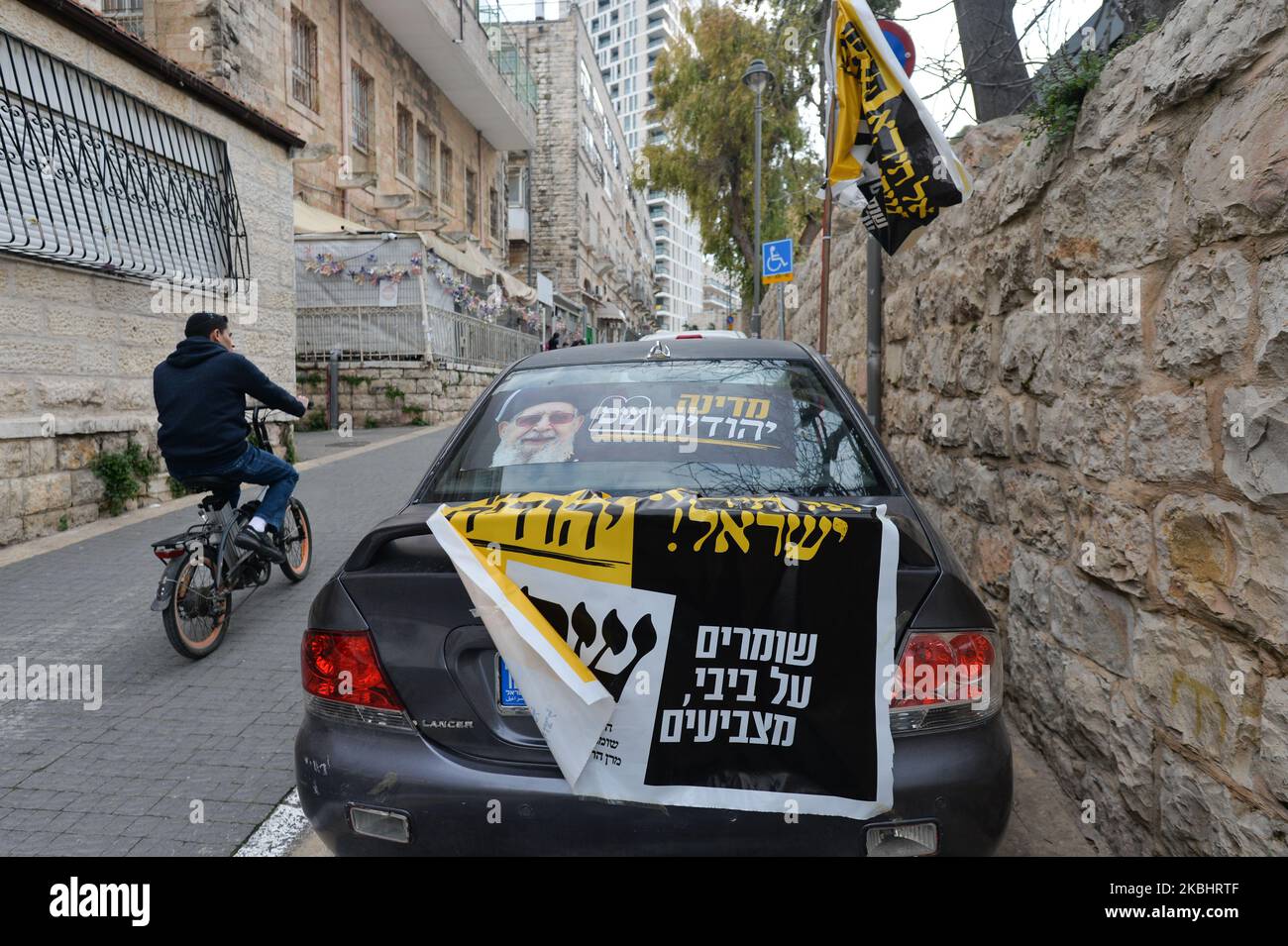 A car covered with election campaign posters for Shas, a Haredi religious political party, in central Jerusalem. Israelis head to the polls for the third election in less than a year on March 2nd. On Monday, February 24, 2020, in Jerusalem, Israel. (Photo by Artur Widak/NurPhoto) Stock Photo